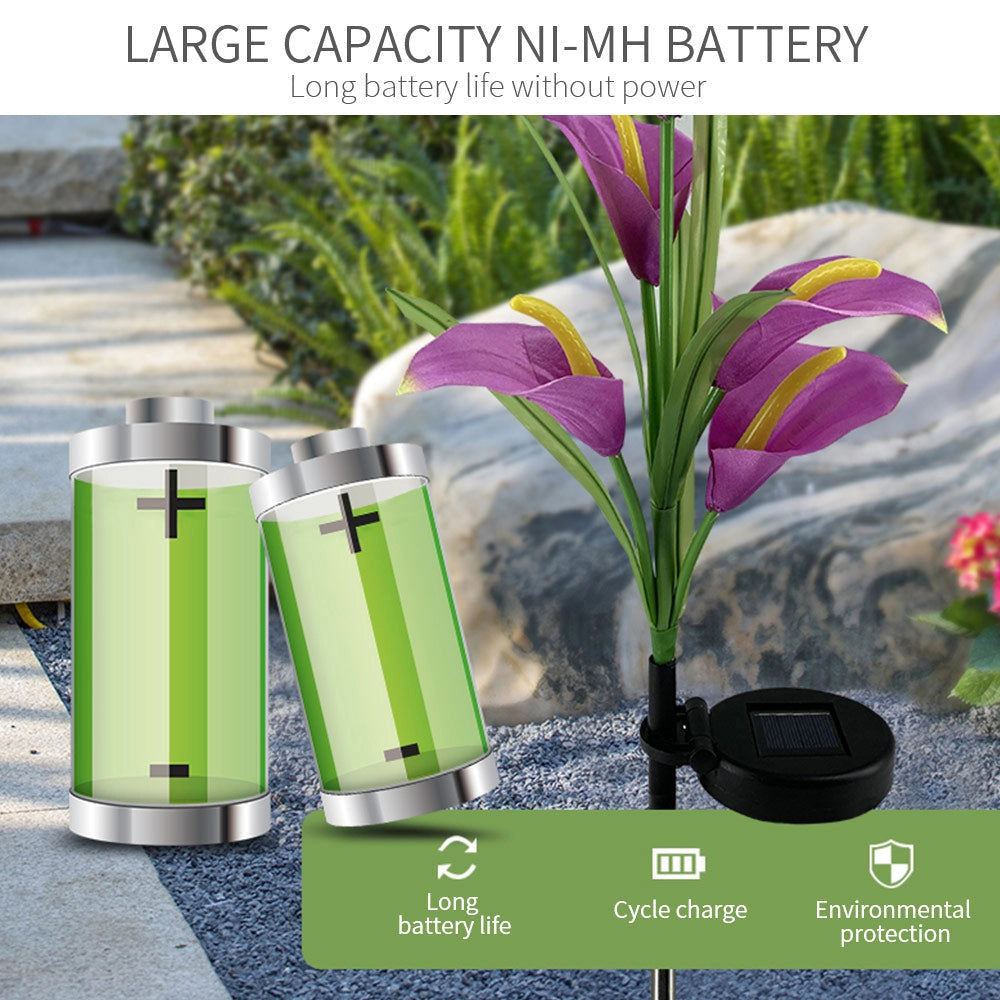 Set of 4 Solar Lily Garden Lights with Multi-color LEDs, depicted as vibrant lily flowers with multicolored petals and green leaves, illuminating a garden area with grass and soil.