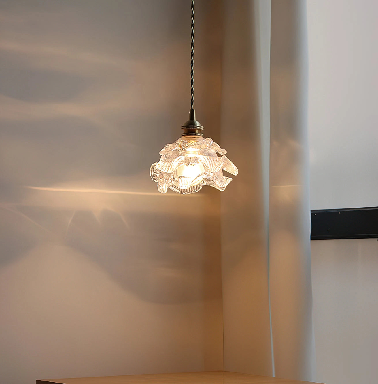 Vintage brass wall light with ornamental rose glass shade, elegant wall sconce featuring natural wood and amber tints.
