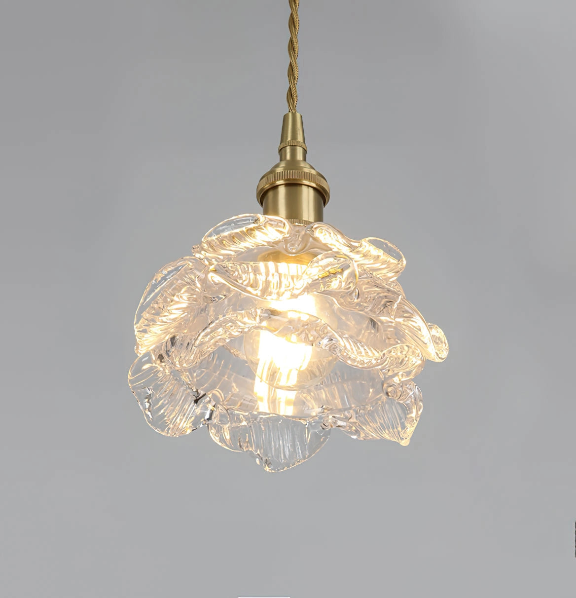 Vintage brass wall light with rose glass shade, elegant wall sconce with intricate detailing and classic design.