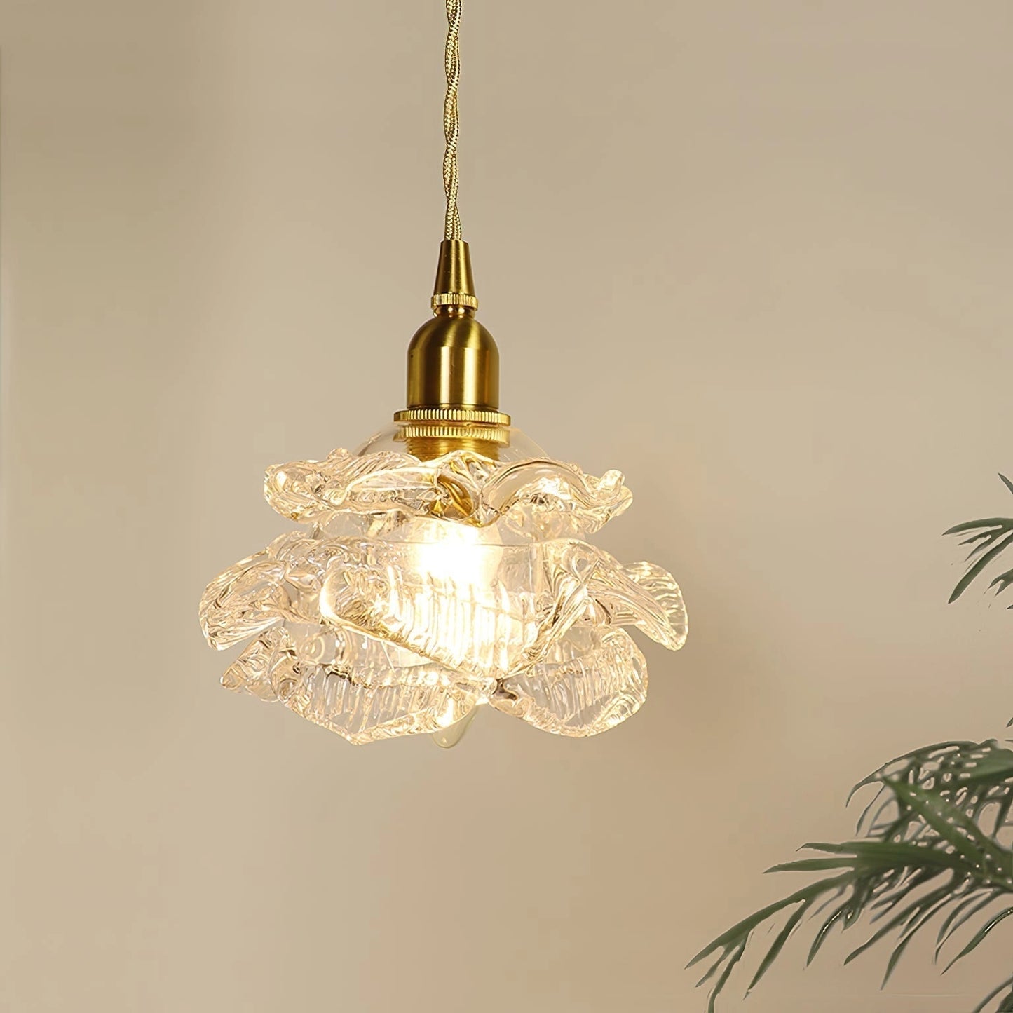 Vintage brass wall light with rose glass shade, elegant wall sconce featuring a circular ornament design.