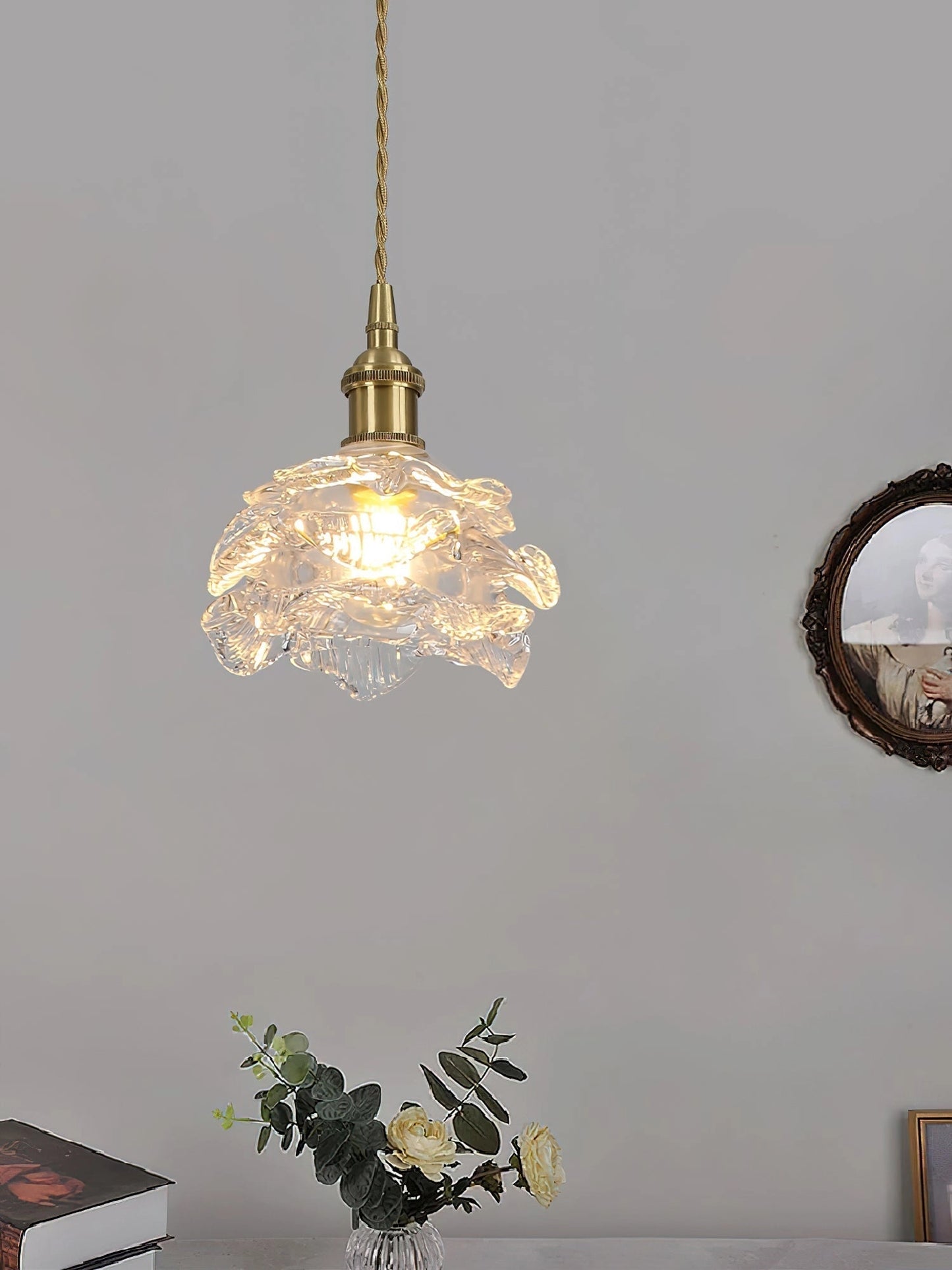 Elegant vintage brass wall light with a rose glass shade, featuring ornamental details and classic design.