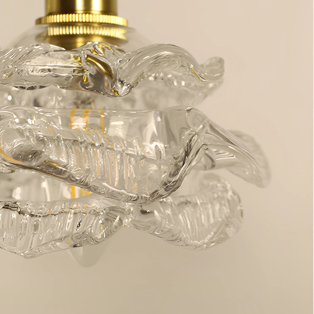 Vintage brass wall light with rose glass shade, elegant wall sconce featuring intricate metalwork and a delicate glass design.
