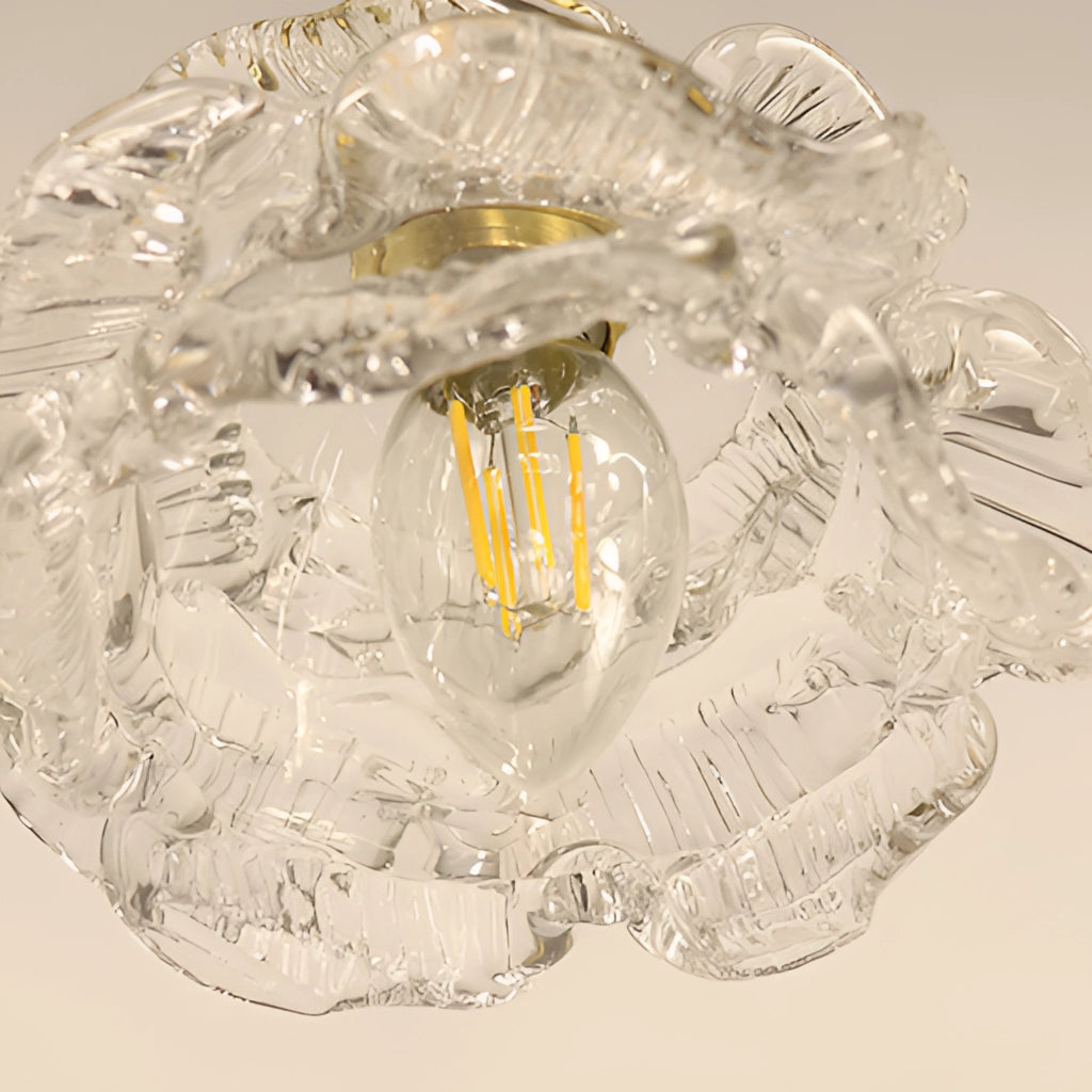 Vintage brass wall light with rose glass shade, elegant wall sconce featuring intricate metalwork and a vintage design.