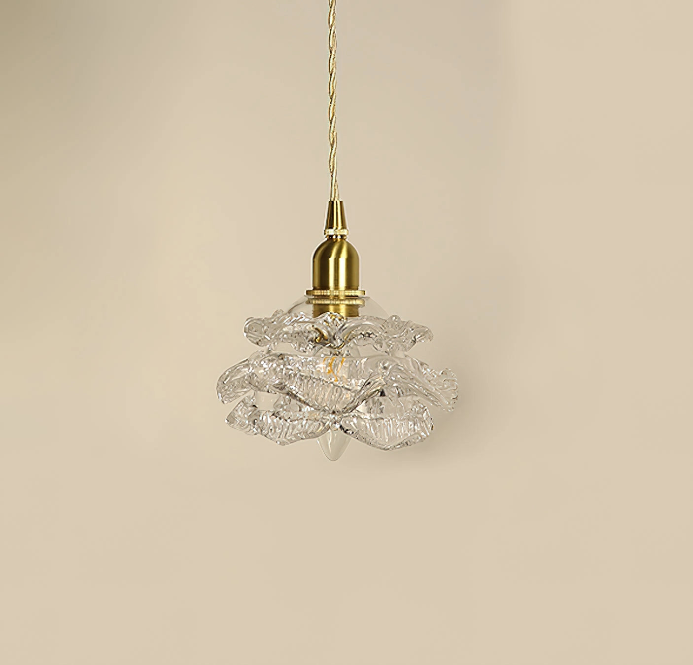 Vintage brass wall light with a rose glass shade, featuring an elegant wall sconce design in gold metal.