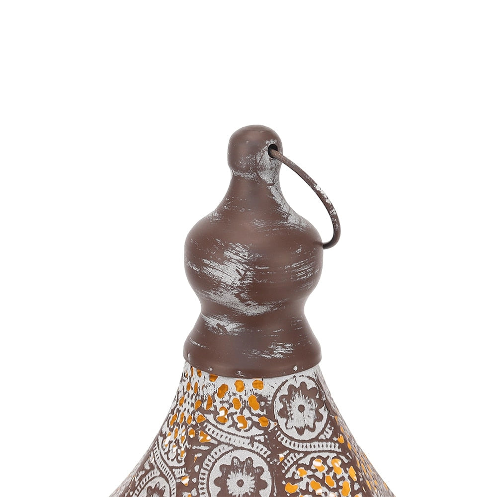 Vintage Moroccan metal lantern with intricate patterns and battery power, showcasing artistic design elements.