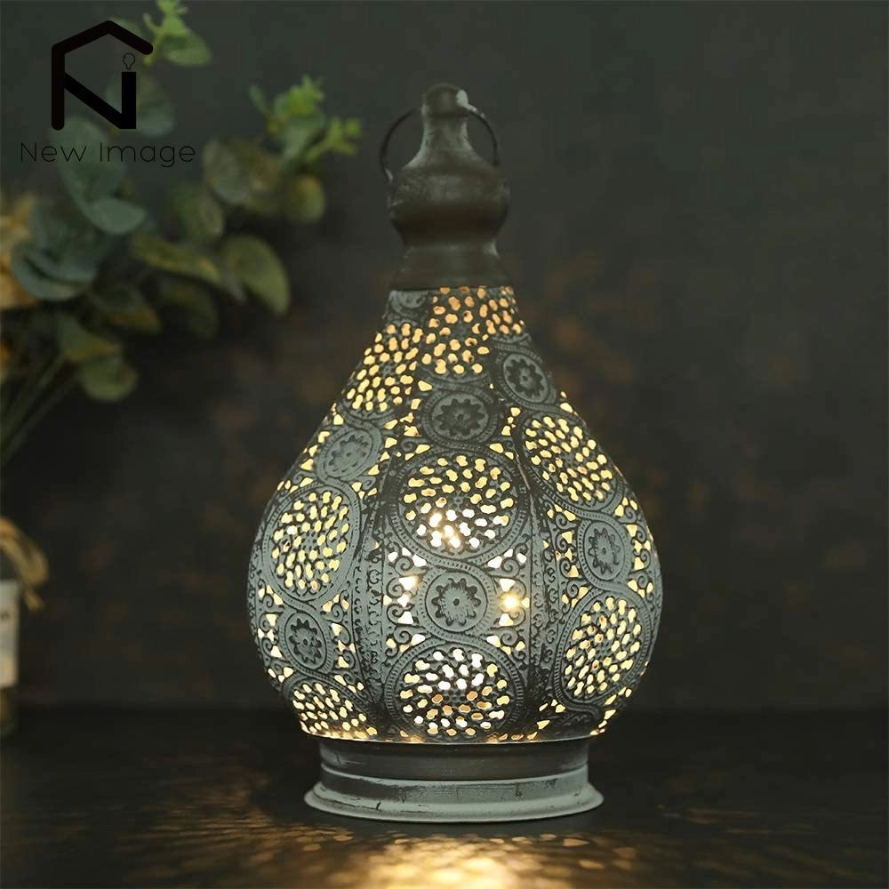 Vintage Moroccan Metal Lantern with intricate design and battery power, displayed on a table.