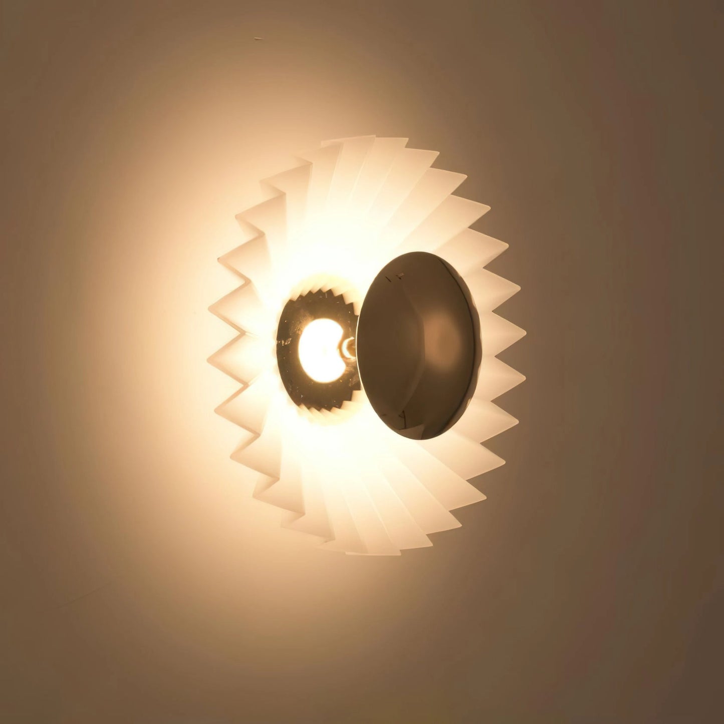 Modern wall lamp with artistic design, featuring premium materials and elegant lighting, mounted on a dark background.