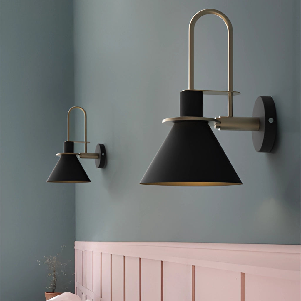 Elegant retro wall light with a matte finish mounted on a wooden panel, illuminating a grey interior space with shelves and flooring visible.