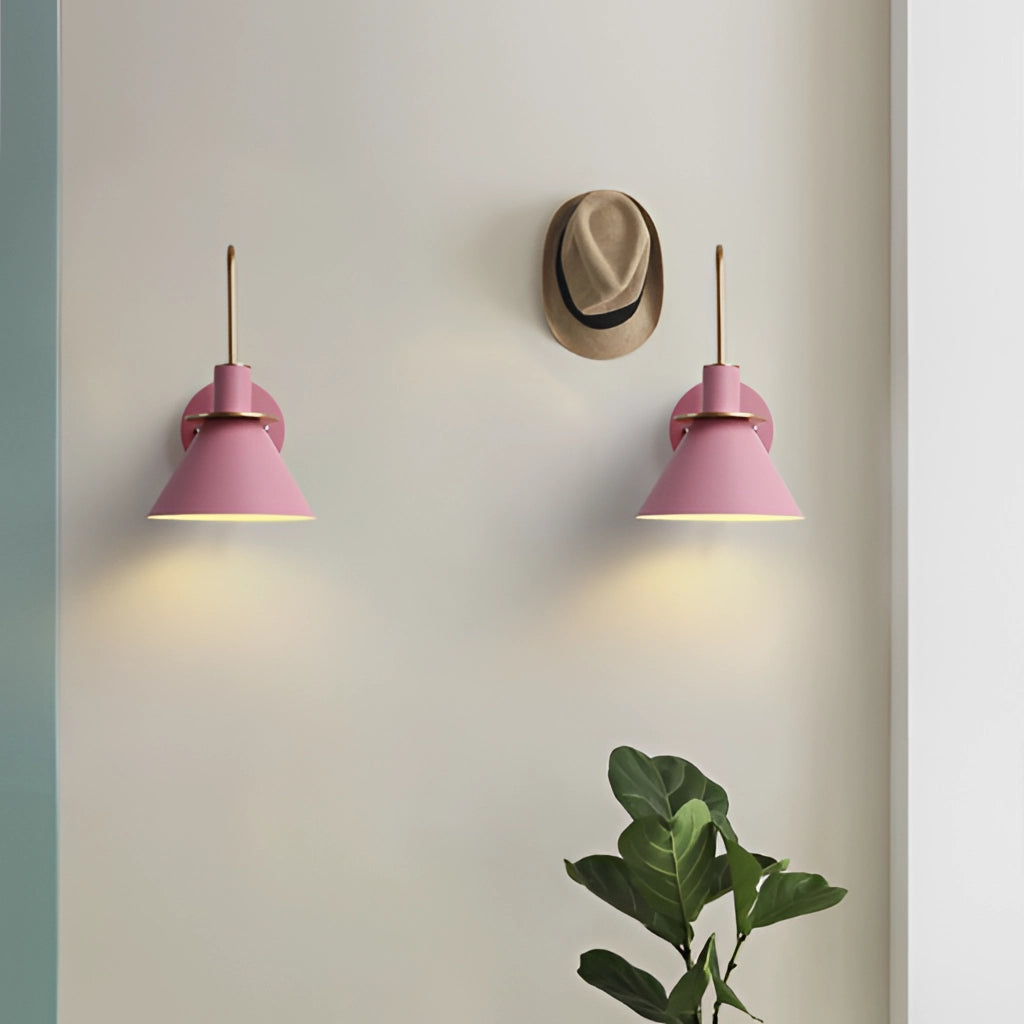 Elegant retro design wall light with matt finish, featuring a wooden base and magenta accents, mounted on an interior wall with a plant nearby.