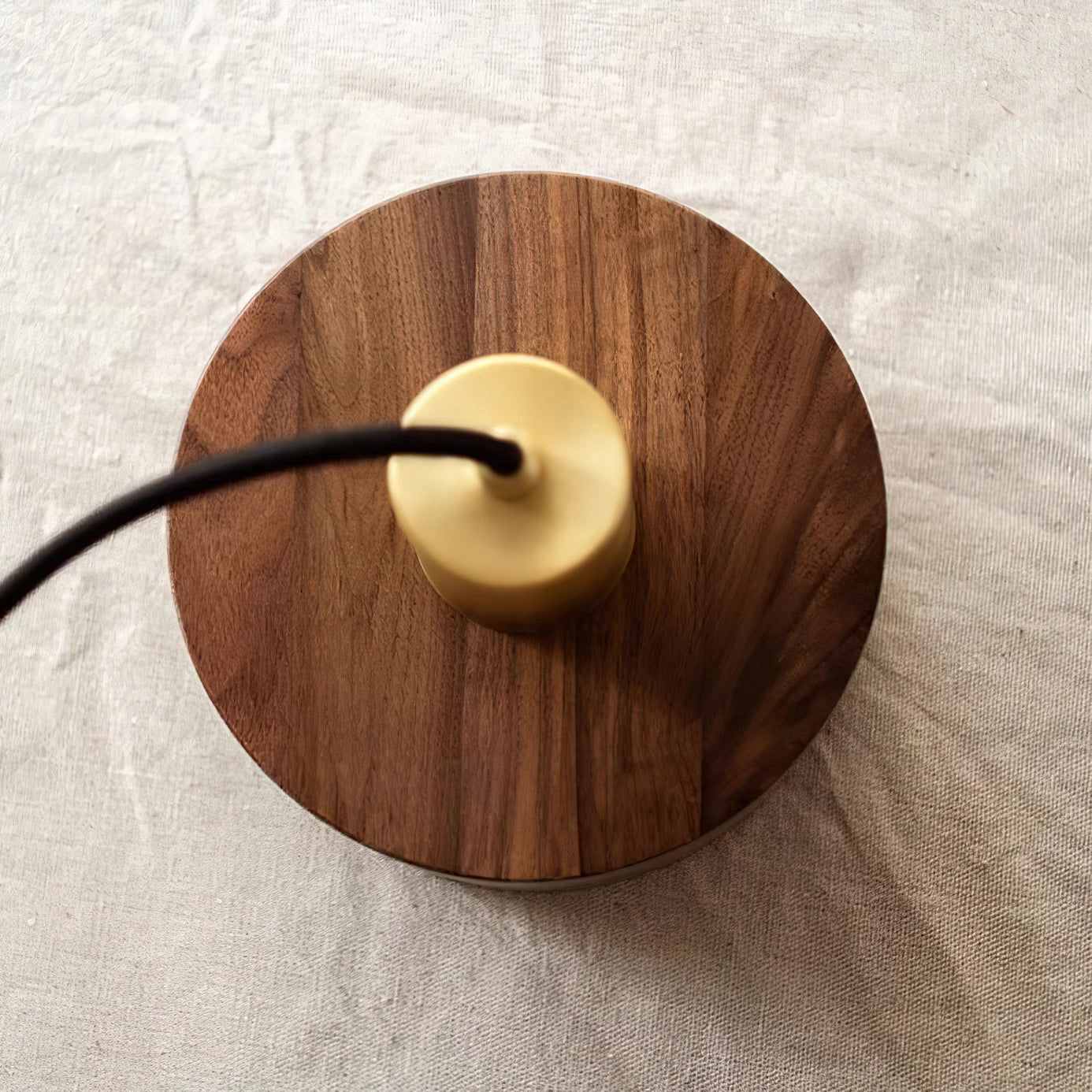 Walnut wood pendant lamp inspired by Japanese woodworking, featuring a circular beige hardwood design with a varnished finish.