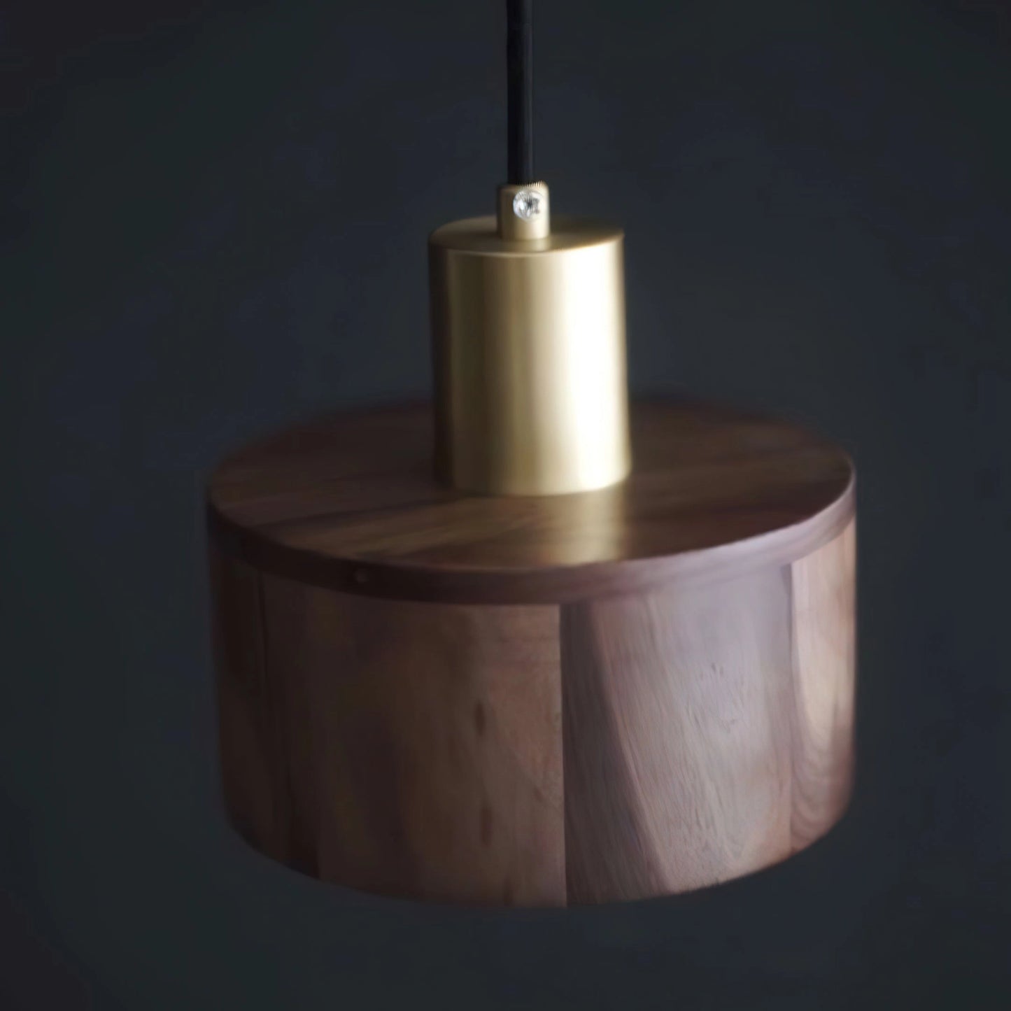 Walnut wood pendant lamp with a cylindrical shape and Japanese woodworking design, featuring a sleek metal ceiling fixture.
