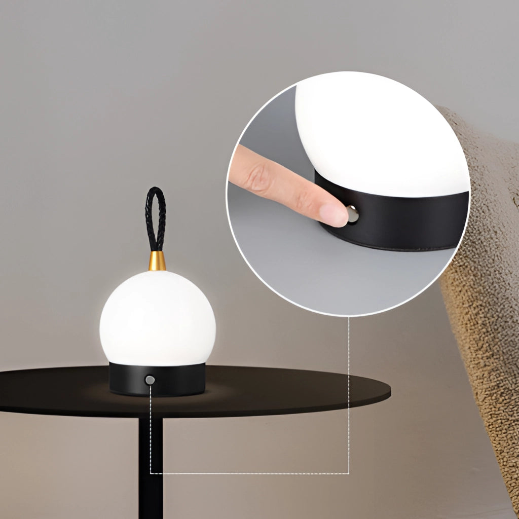 Waterproof LED table lamp in a cordless orb design, featuring a sleek wooden base and modern circular light fixture.