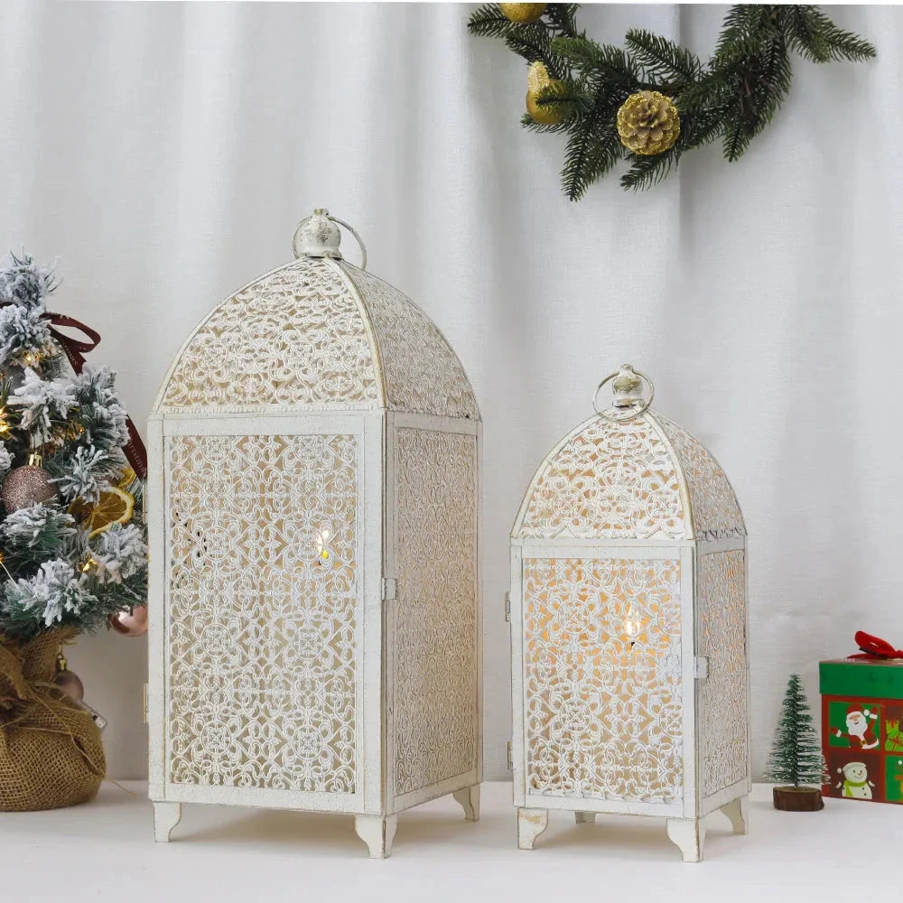 Set of 2 white gold metal candle lanterns used for indoor and outdoor decor, displayed in a stylish interior setting.