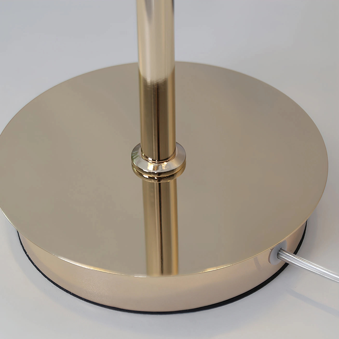 Adjustable Nordic Style Wall Lamp with Rotatable Design mounted on wall, with cylindrical metal lamp shade beside a wooden table and chair.
