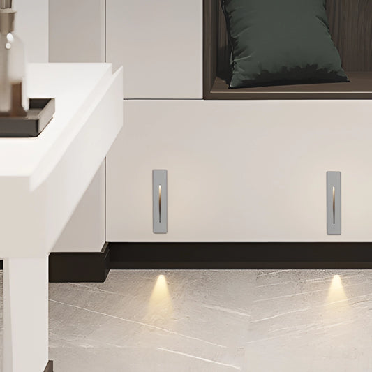 Modern rectangular ambient glow wall light in black, white, and light grey, made of waterproof aluminum, suitable for indoor and outdoor spaces, mounted on a wooden surface.
