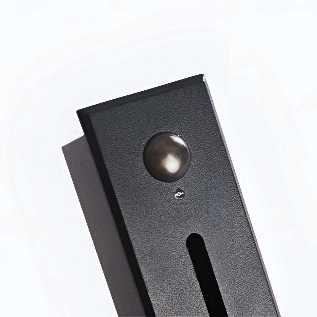 Modern black and white ambient glow wall light mounted on an outdoor wall near a door, featuring a sleek rectangular design in light grey aluminum.