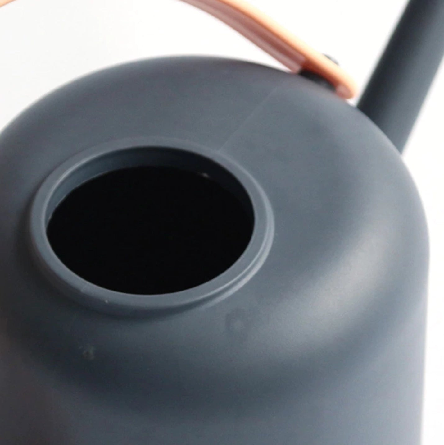 Modern and functional garden watering can with a sleek design, suitable for April showers, placed on a table.