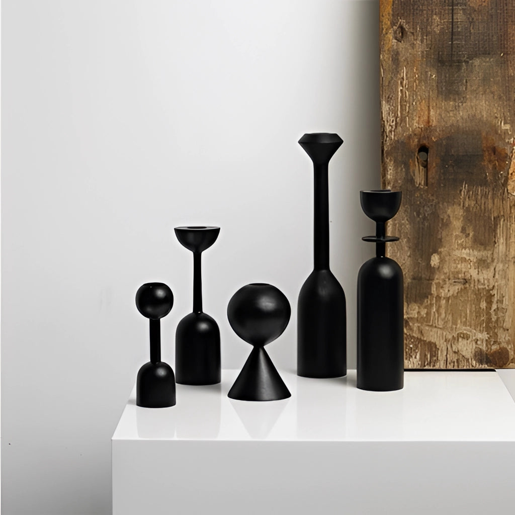 Black wooden candle holder set for home decor displayed on a wooden surface, showcasing cylindrical design and elegant craftsmanship.