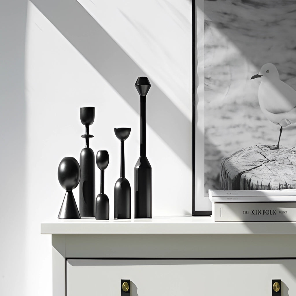 Black wooden candle holder set for home decor with intricate carvings and elegant design, displayed on a white background.