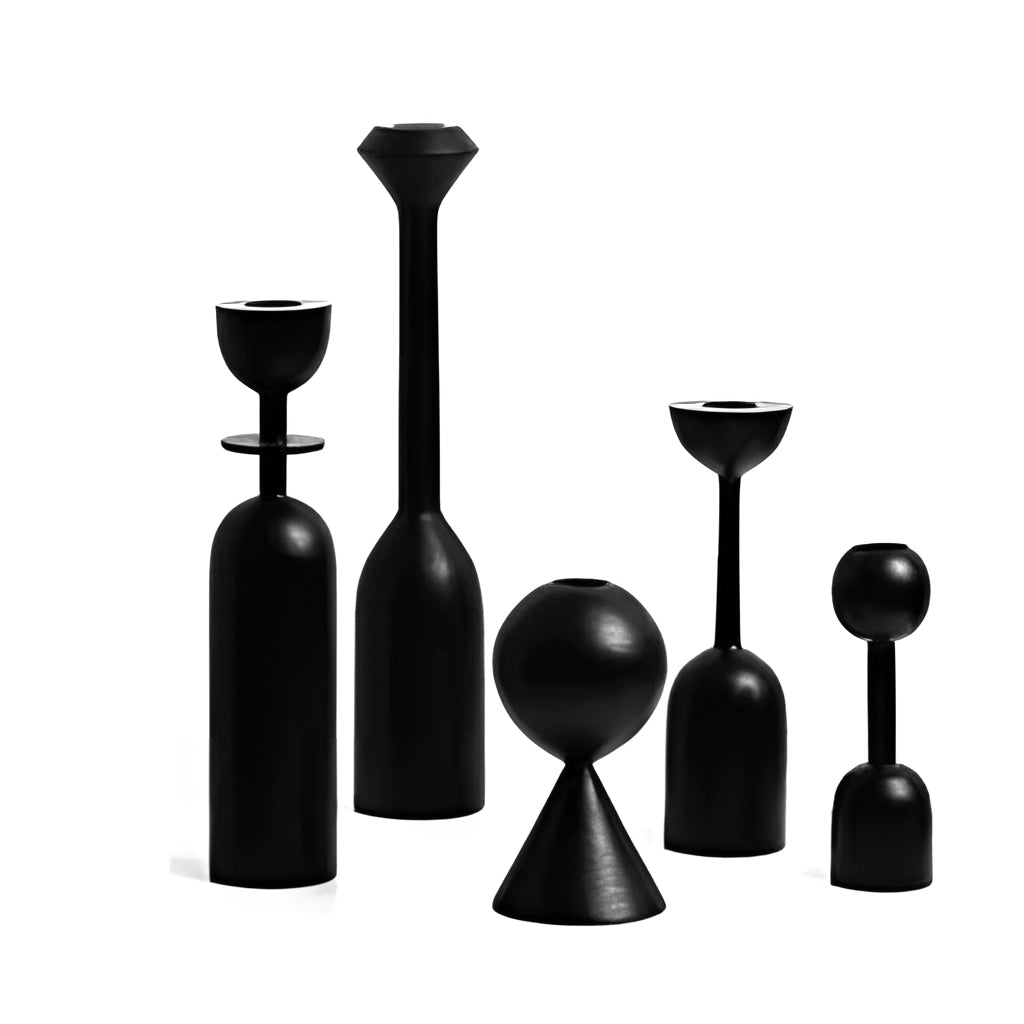 Set of five black wooden candle holders for home decor, displayed on a surface.