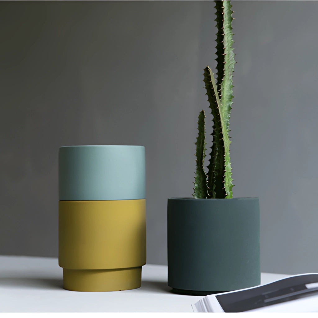 Bright porcelain stackable flowerpot planters in ocean tones, displayed with houseplants, featuring both cylindrical and rectangular shapes.