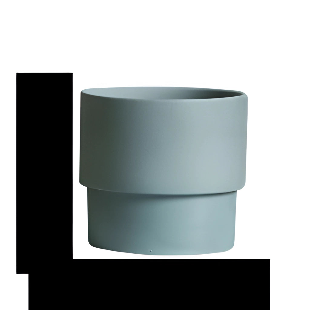 A set of bright blue porcelain stackable flowerpot planters arranged on a table.