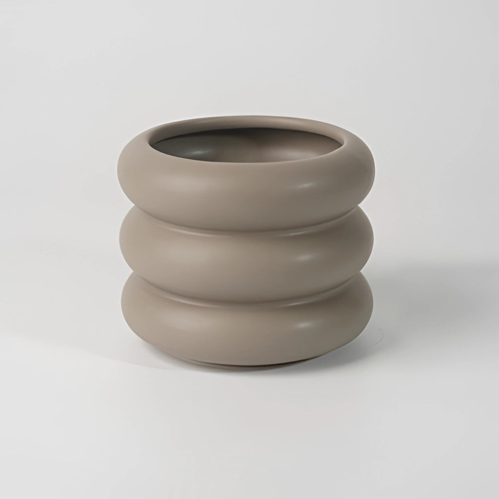Ceramic round bubble glass planter vase on a wooden surface with artistic design.