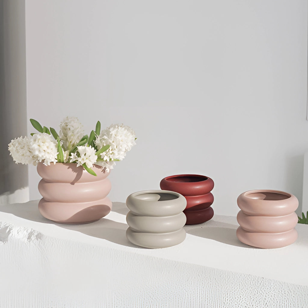 Ceramic round Bubble Glass planter vase with a small plant inside, placed on a table.