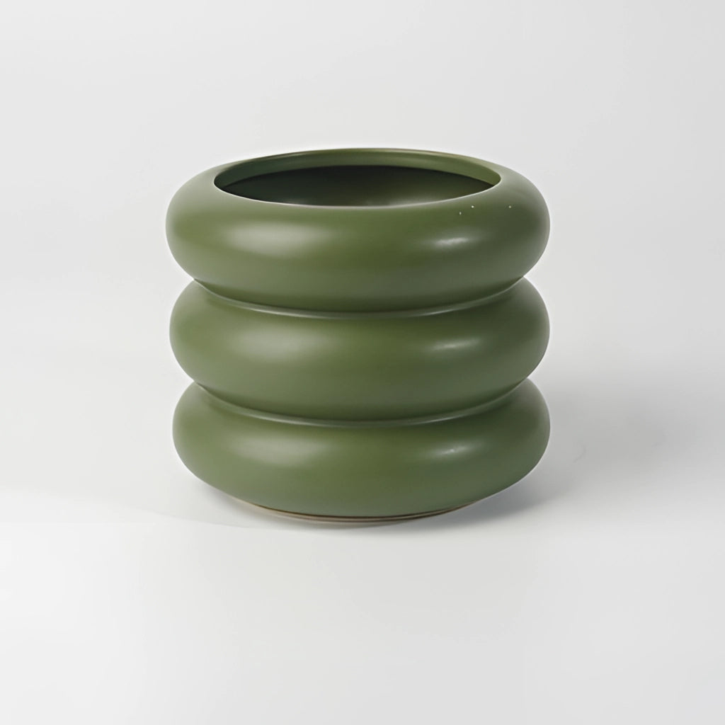 A round ceramic bubble glass planter vase with a contemporary design, displayed on a table.