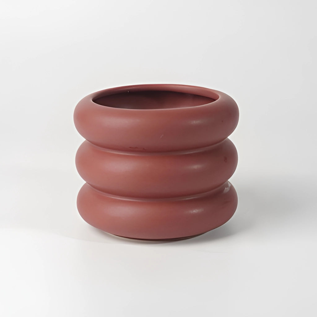 Ceramic round bubble glass planter vase with a smooth peach finish, resembling fine dishware and pottery art.