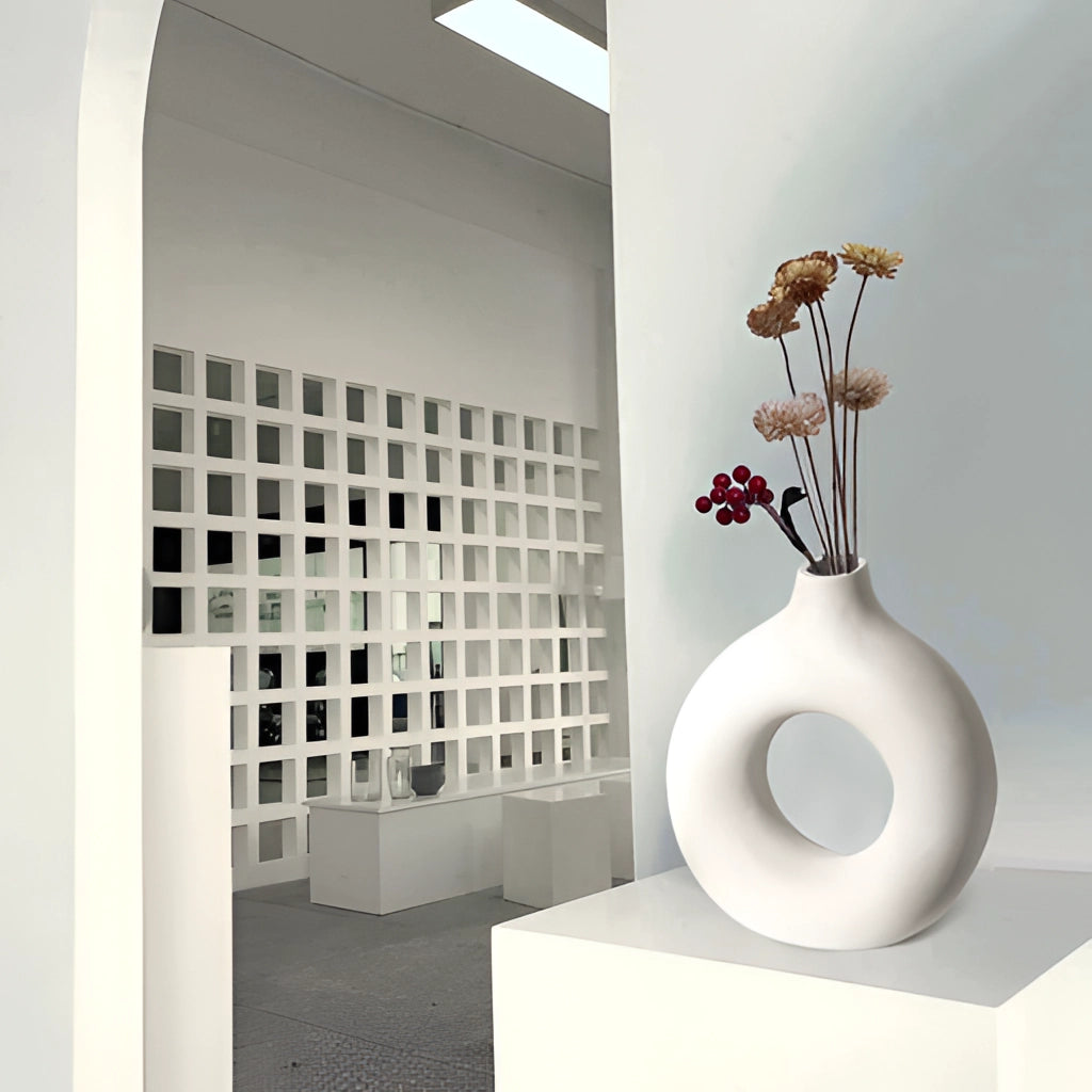 Ceramic donut-shaped vase displayed in a modern home setting with minimalist interior design.