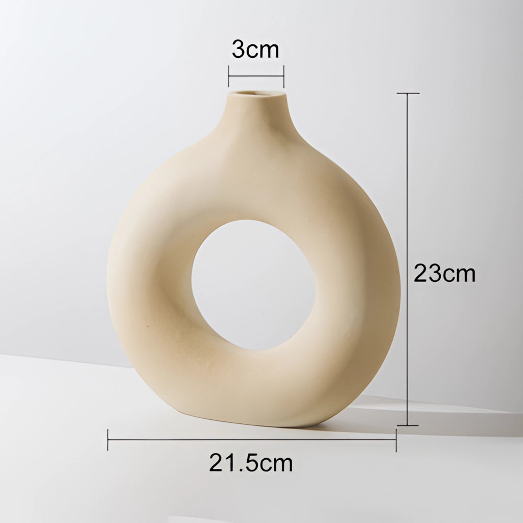 Beige large ceramic donut-shaped vase for modern home decor.