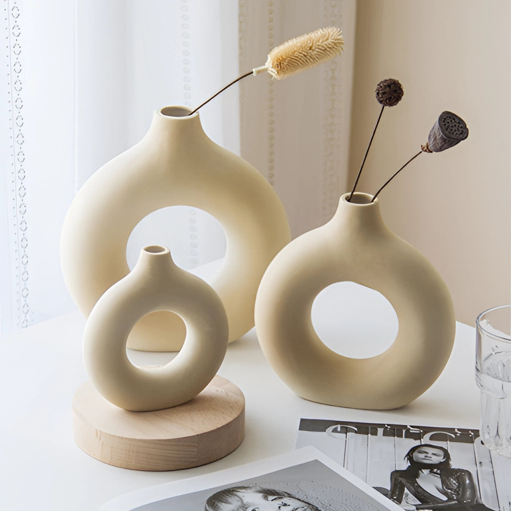 Ceramic donut shape vase with a smooth finish, ideal for modern home decor, featuring a circular design and minimalist aesthetic.