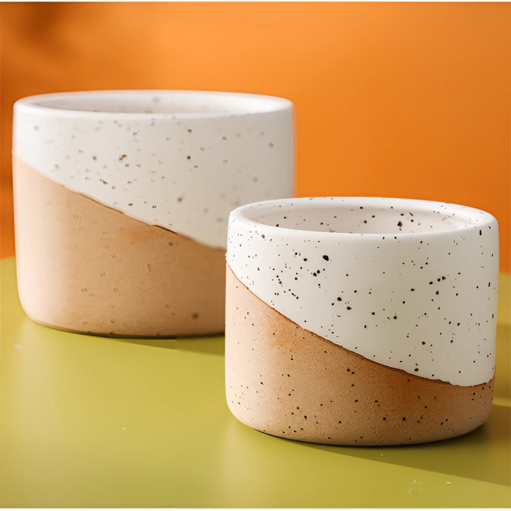 Small, medium, and large ceramic flowerpots in linen color, cylindrical shape, displayed on a surface.