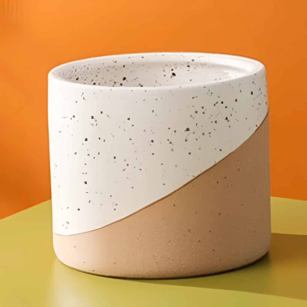 A set of small, medium, and large ceramic flowerpots in linen color displayed on a surface.