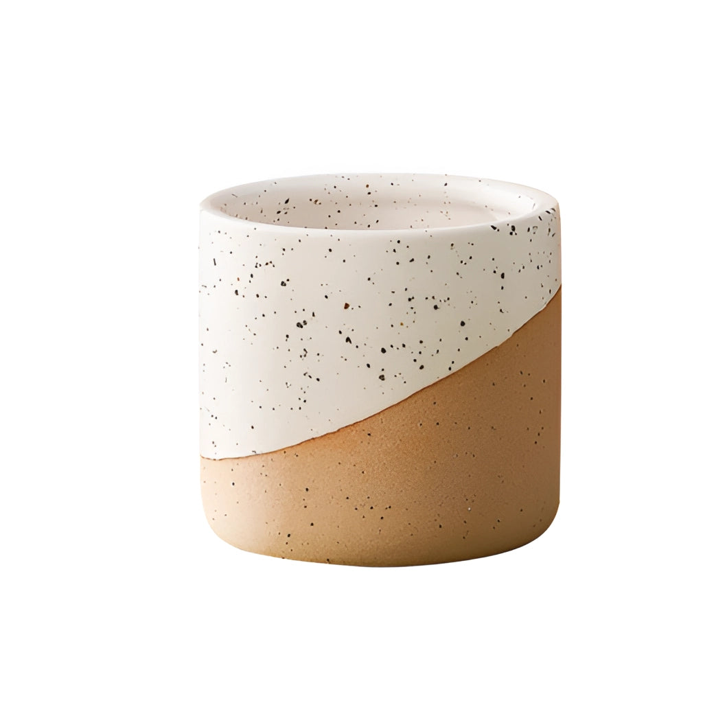 Large ceramic flowerpot in linen color with a cylindrical shape, placed on a table.