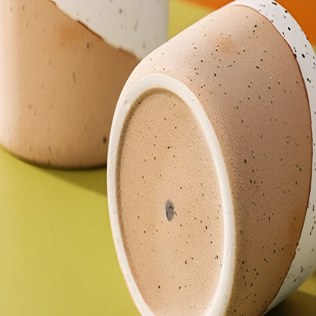 Ceramic flowerpot in linen finish, available in small, medium, and large sizes, displayed on a table.