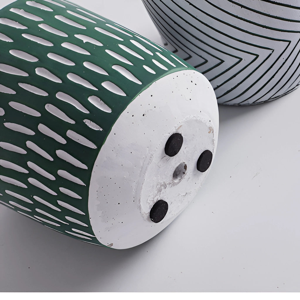 Hand-painted ceramic planter with textured designs, featuring a cylindrical shape and intricate patterns.