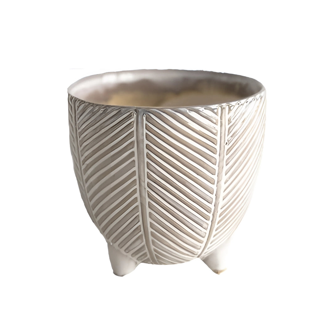 A large Tahiti ceramic plant pot with a holiday design, placed on a wooden table outdoors.