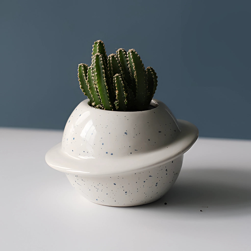 Ceramic Planet Plant Pot in White with Astral Galaxy Design, featuring a houseplant inside.