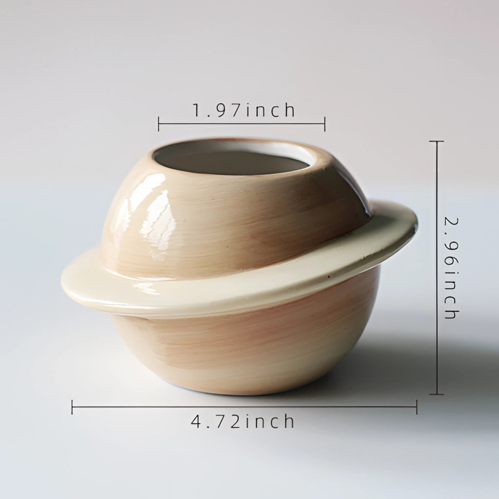 A yellow ceramic plant pot with an astral galaxy design, featuring artistic and creative patterns, displayed on a wooden surface.