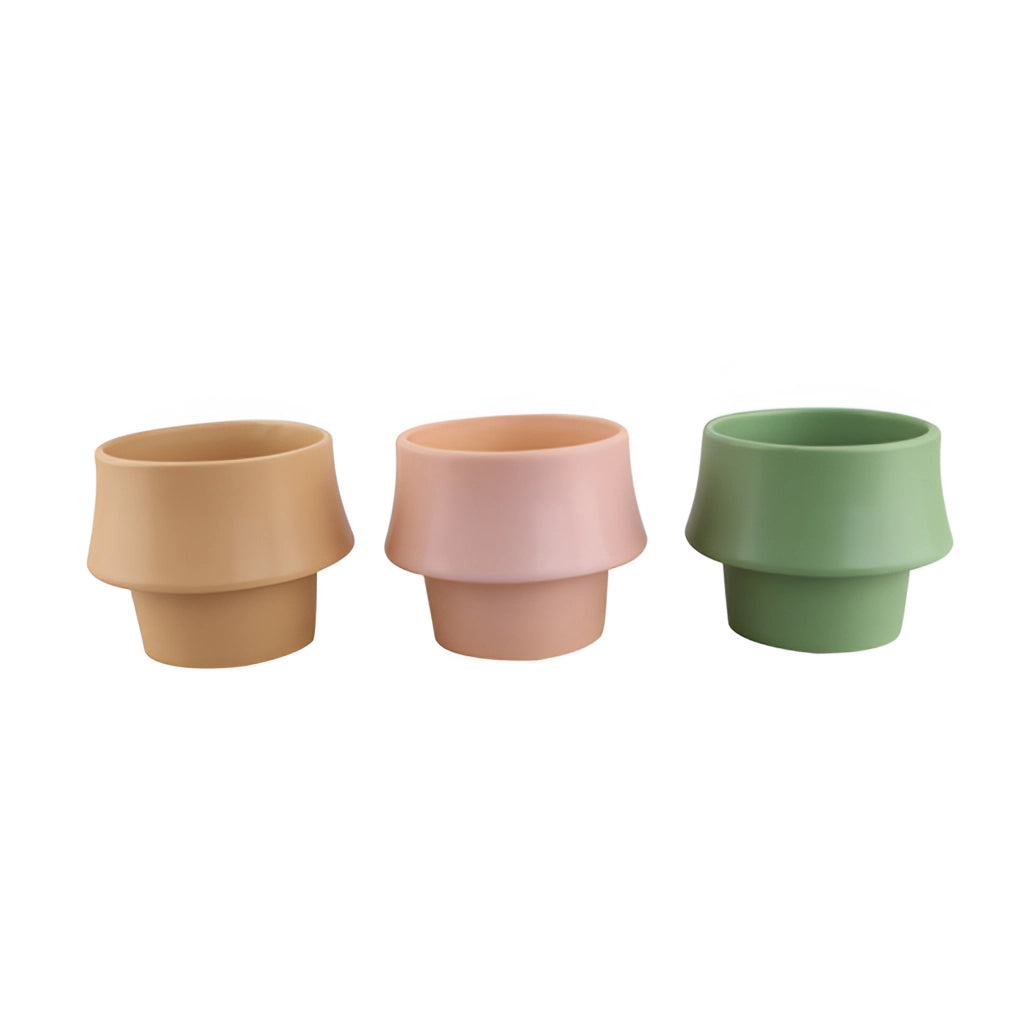 Ceramic planter in Rosa with a glazed finish, featuring a Scandinavian style design, displayed on a wooden surface.