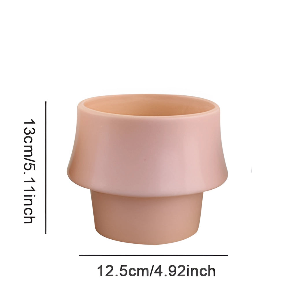 Ceramic Planter in Rosa - Glazed Finish Scandinavian Style Pot with a smooth, cylindrical design and a shiny pink surface.