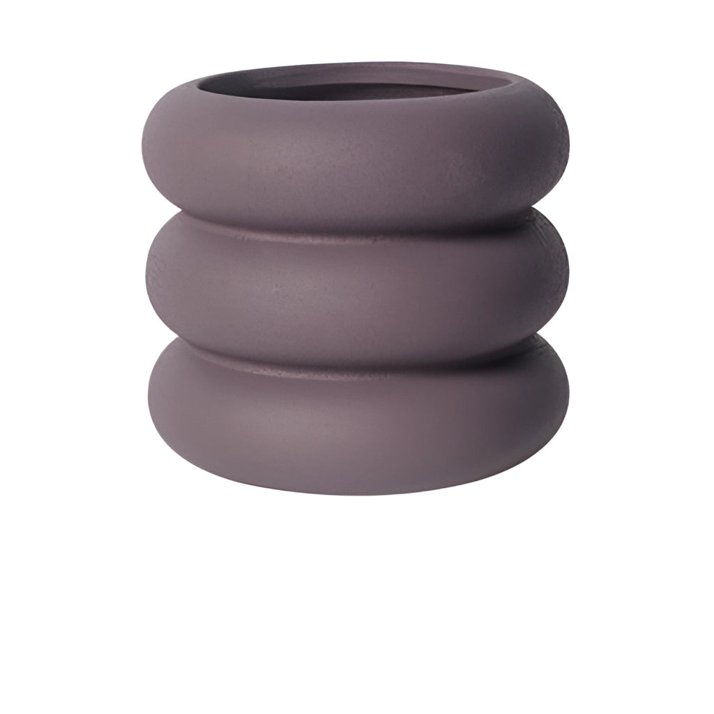 Large purple ceramic round plant pot on display.