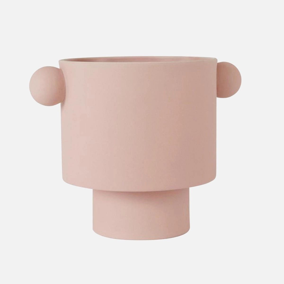 Hand-molded ceramic vase with Scandinavian design in earthy tones, in a large size and rosewater color, placed on a wooden surface.