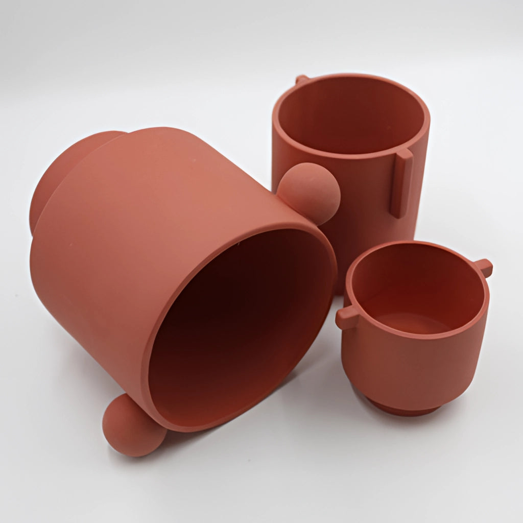 A hand-molded ceramic vase with a Scandinavian design in earthy tones, available in small and large sizes, featuring a cylindrical shape.