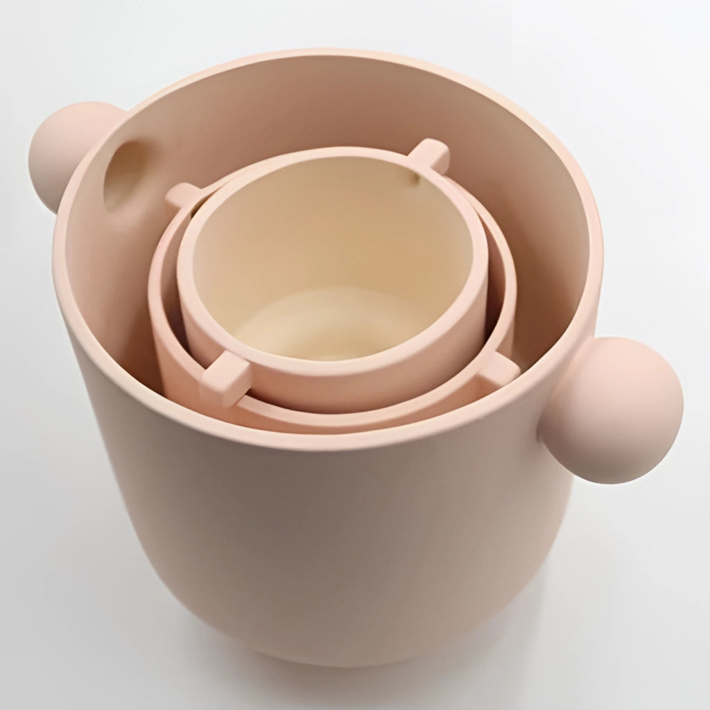 Hand-molded ceramic vase in earthy tones with Scandinavian design, displayed on a wooden surface.