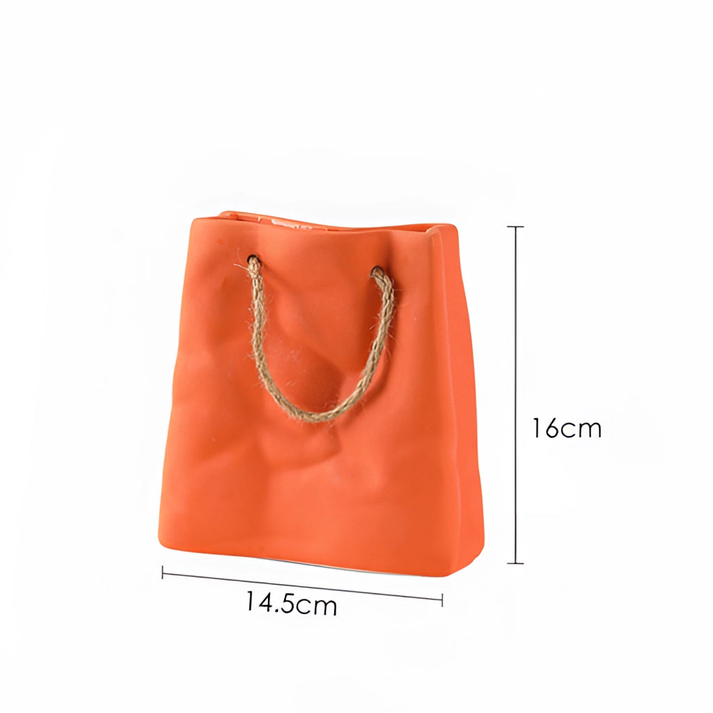Orange ceramic vase with shopping basket design.