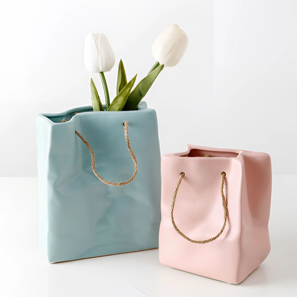 Ceramic vase with shopping basket design, featuring a rectangular shape and floral petal details.