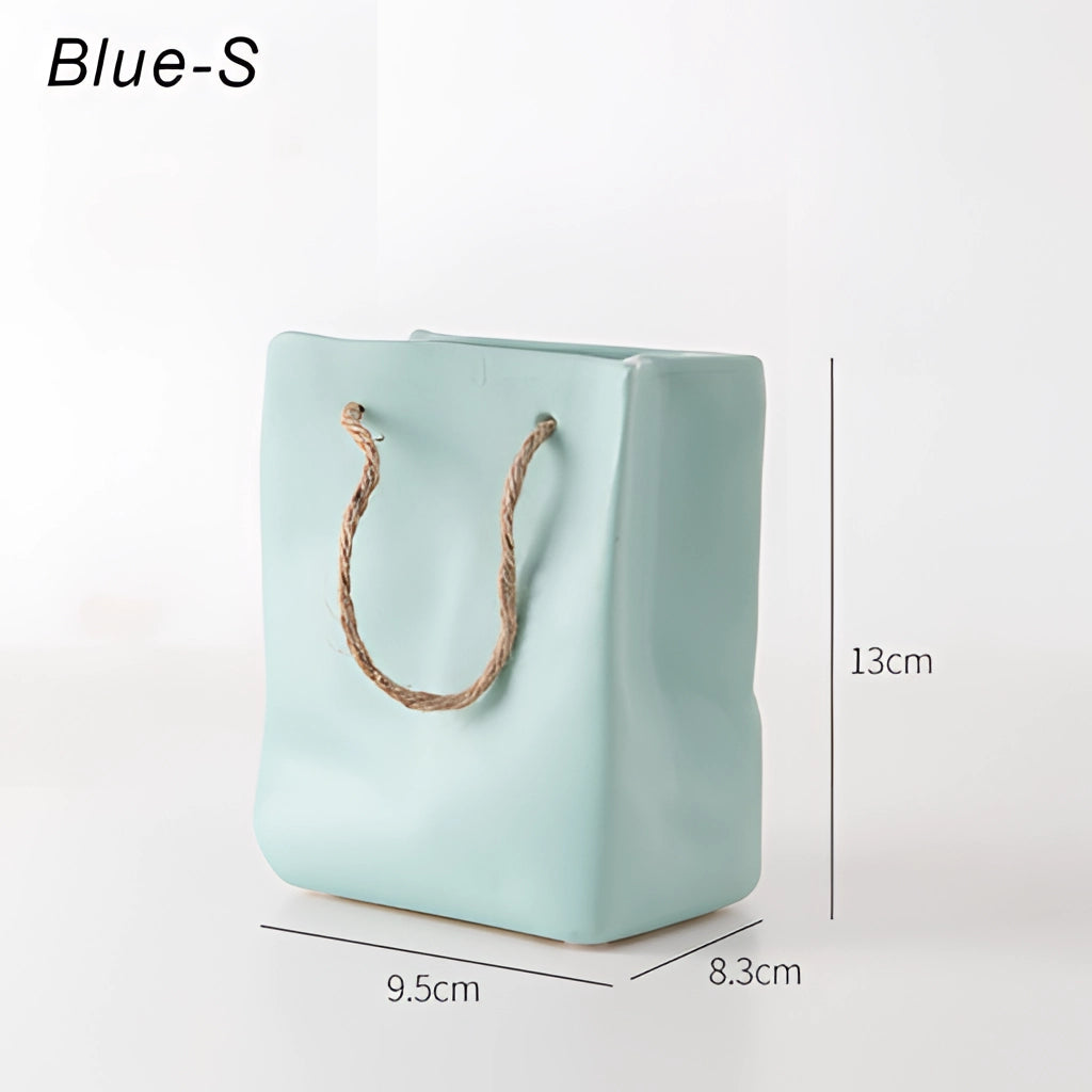 A ceramic vase featuring a unique shopping basket design, with rectangular elements and electric blue accents.
